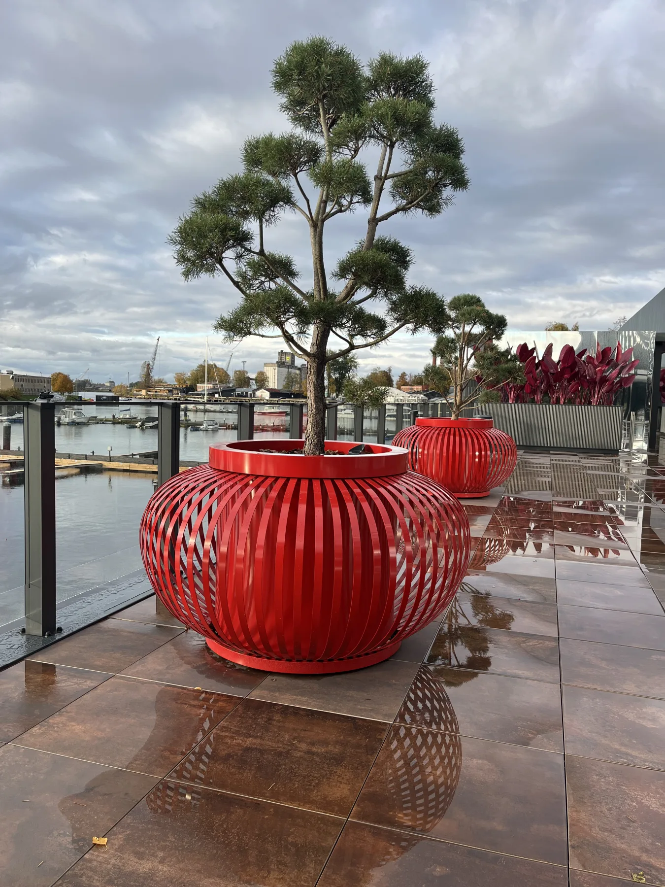 Close view of red ribbed planters on the waterfront terrace